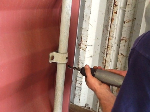Drilling holes in a shipping container